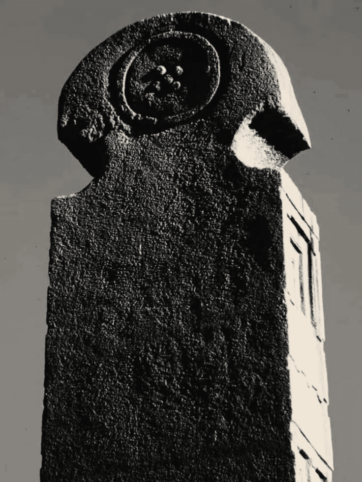 The carved crown of the standing stele.